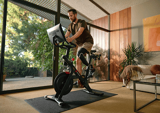 man riding Peloton bike