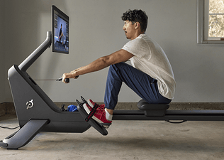 Man does a full-body workout on a rowing machine