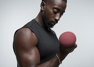 A man lifting a dumbbell in a bicep curl.
