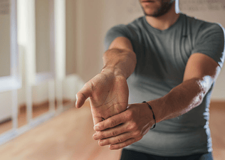Man doing a wrist flexor stretch