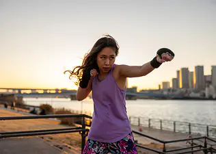 Woman throws a jab in boxing outside