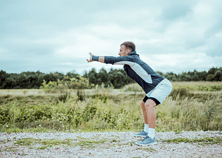 Man does a hip hinge exercise