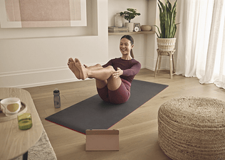 woman practices Pilates at home 