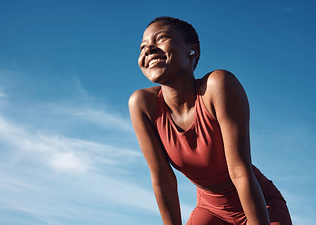 Woman smiling while exercising outside