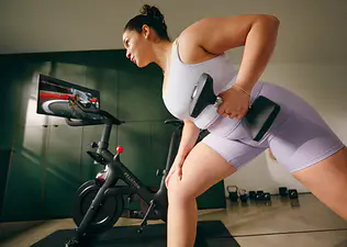Woman does a strength training Peloton class 