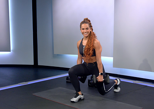 Jess Sims demonstrates a reverse lunge in a Peloton class 