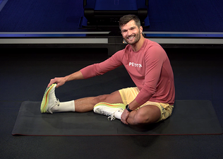 Jon Hosking demonstrates a static stretch in Peloton class