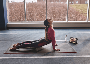 Peloton member taking a yoga class on the Peloton App