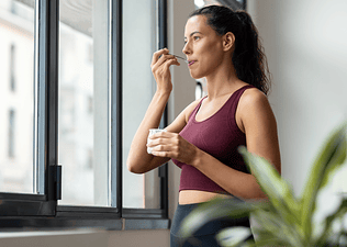A view of a woman eating Greek yogurt after an endurance run.