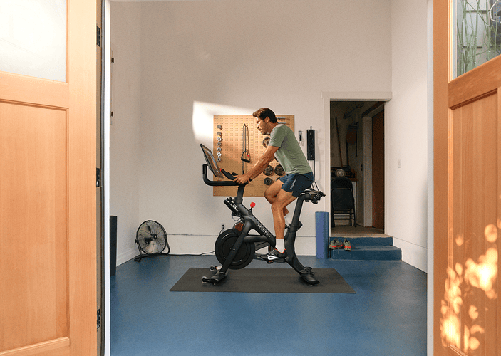Man on a Peloton Bike+ doing light cardio on a rest day.
