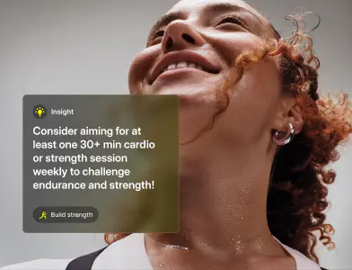 A lady with curly red hair tied up wearing a silver earring looks up towards a light shining on her face.  Overlaid on the image is an info card that reads Insight Consider aiming for at least one 30+ min cardio or strength session weekly to challenge endurance and strength! Build Strength.