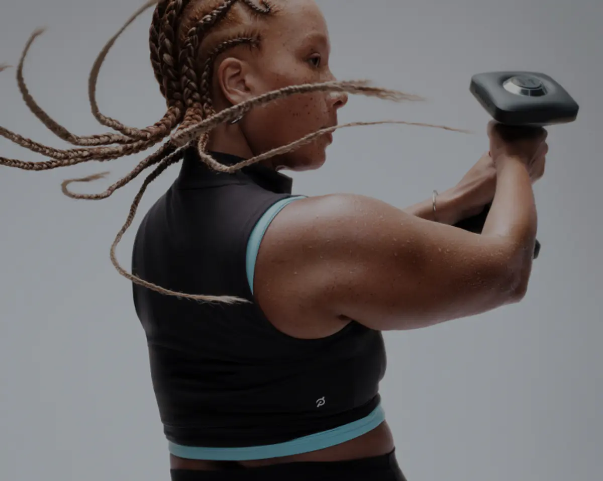 Woman working out using Peloton App