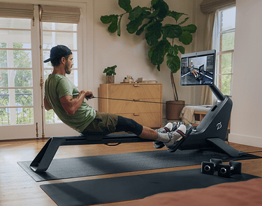 Man rowing in his living room with his Peloton Row