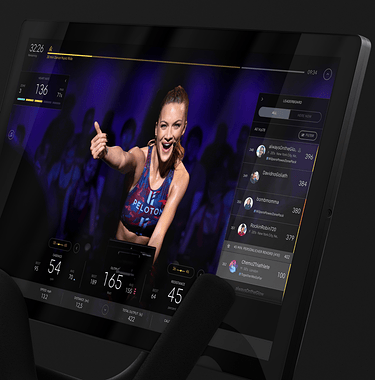 Peloton Bike screen with Peloton instructor teaching a class on-screen.