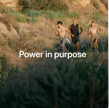 Three runners trail running on a grassy hillside with text overlay reading, Power in purpose.