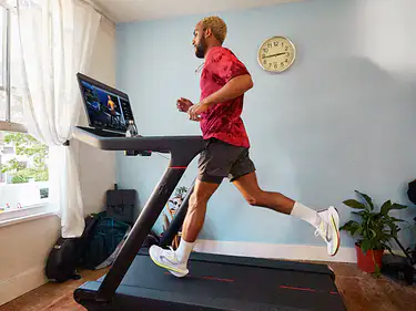 Man running on Peloton Tread