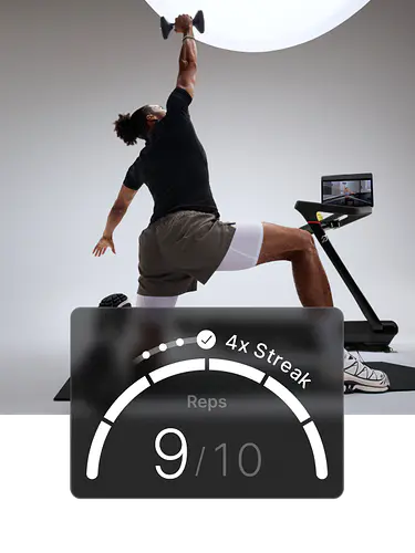 A man is kneeling on a mat with one arm extended overhead, holding a dumbbell, beside a Peloton Tread+. Overlay shows “Reps 5/6.”