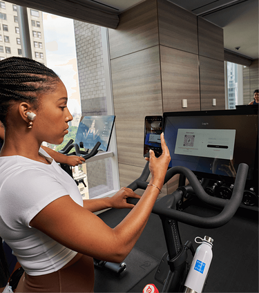 woman logging in on Peloton bike