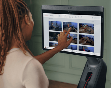 Woman selecting a Peloton class on her Peloton Row