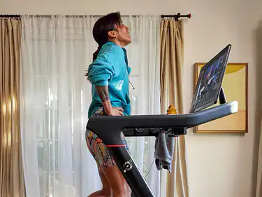 woman on Peloton Tread with safety key