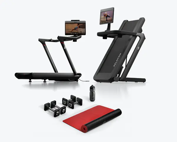 Peloton Tread treadmill shown setup flat and folded upright, accompanied by dumbbells, a water bottle, and a exercise mat.