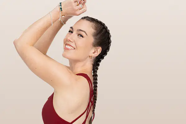 Instructor in a blue Peloton outfit posing during a yoga session.