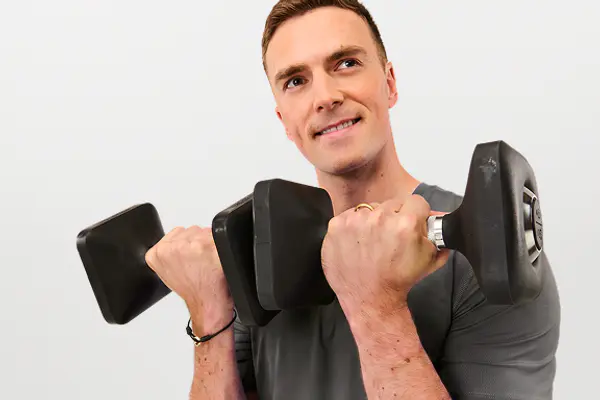 Strength instructor performing a single-arm dumbbell row exercise.