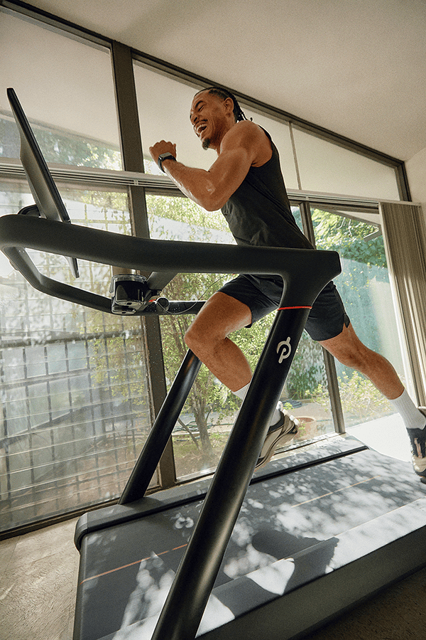 Peloton member using the tread to take a strength class