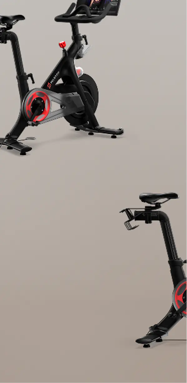 Two Peloton bikes, one showing the front handlebars and screen, and the other showing the seat and frame, on a neutral background.