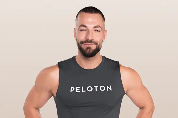 Instructor running on a Peloton Treadmill while looking ahead with focus.