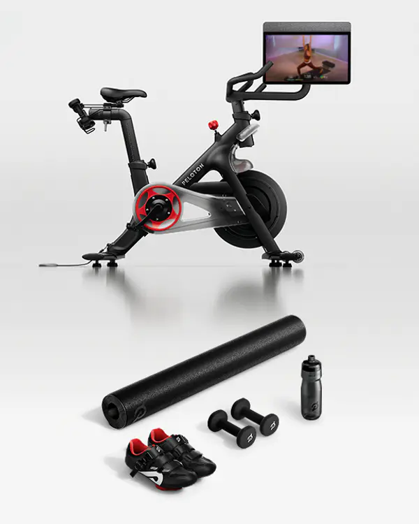 Peloton Bike, bike mat, cycling shoes, dumbbells and water bottle