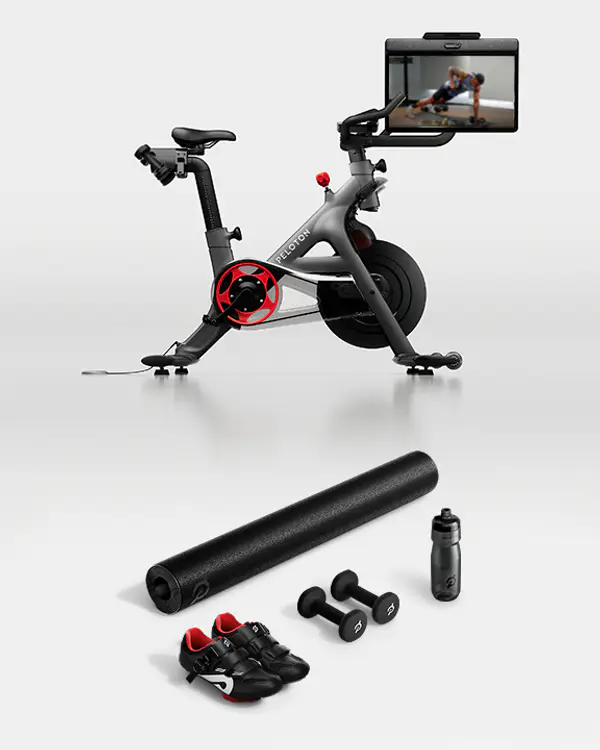 Peloton Bike+, bike mat, cycling shoes, dumbbells and water bottle