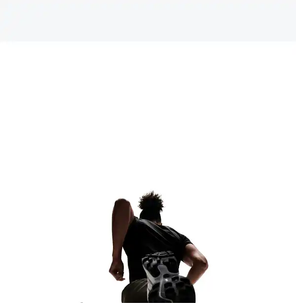 Rear angle of a runner on a Peloton Tread overlaying workout metrics like incline, output, and pace.
