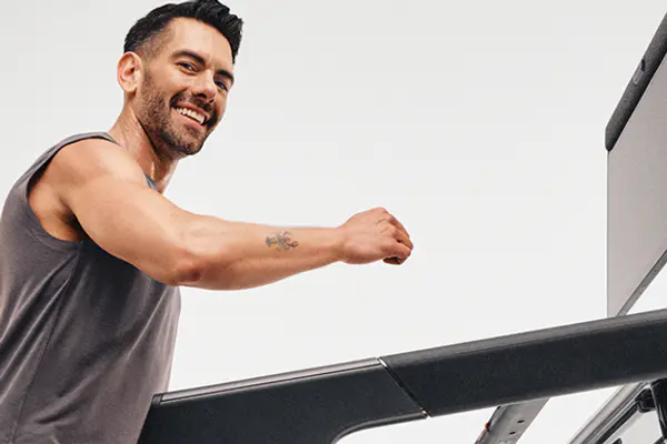 Peloton instructor walking on Peloton Tread