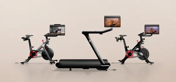 Peloton Bike+, Tread+, and Row+ machines arranged against a neutral background, each displaying a workout class on its screen.