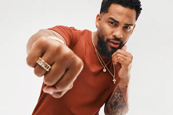 Boxing instructor posing in a mid-punch stance while looking directly at the camera.