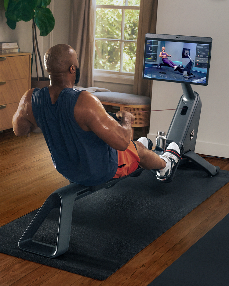Woman exercising with Peloton Row