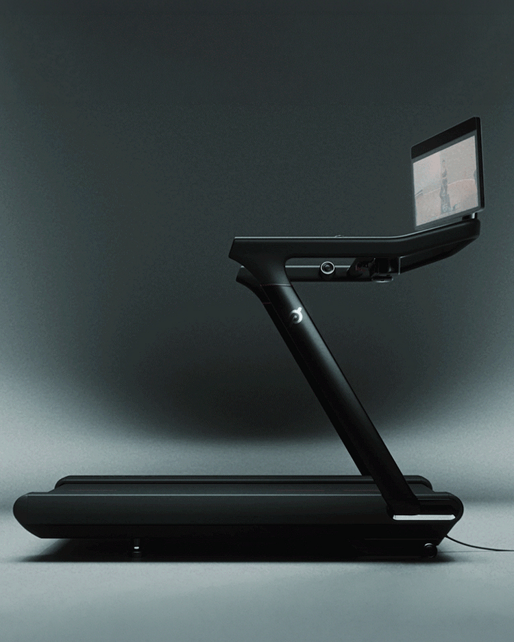 Side profile of a black Peloton Tread with a digital workout overlay showing running statistics.