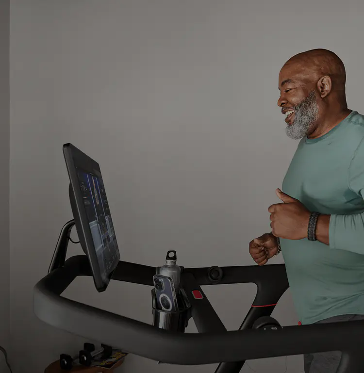 Man running on Peloton tread at home