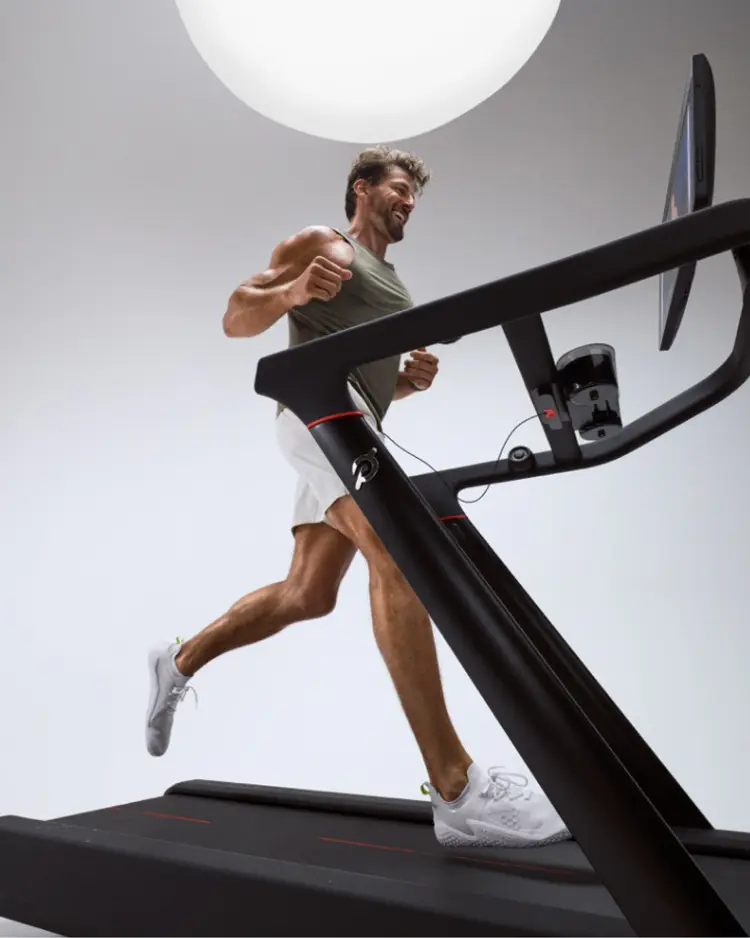 Man running on a peloton cross training Tread