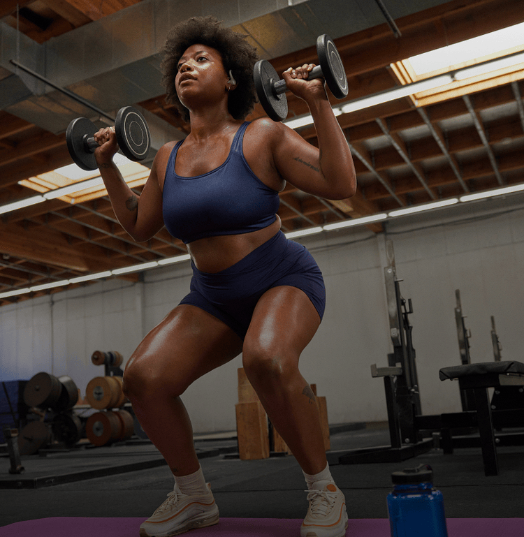 Women doing a squat with weights