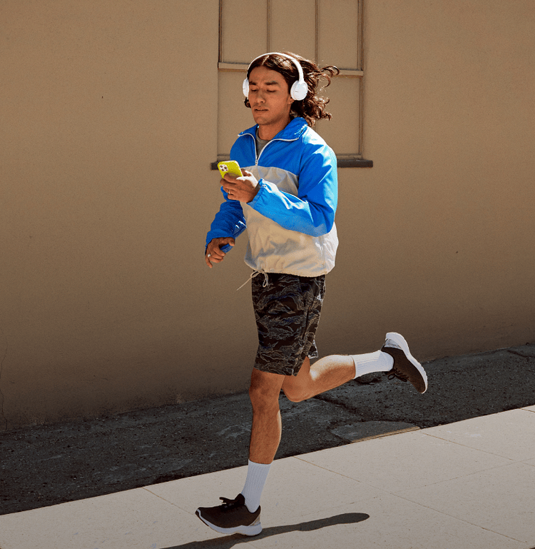 Man running outside using the Peloton app