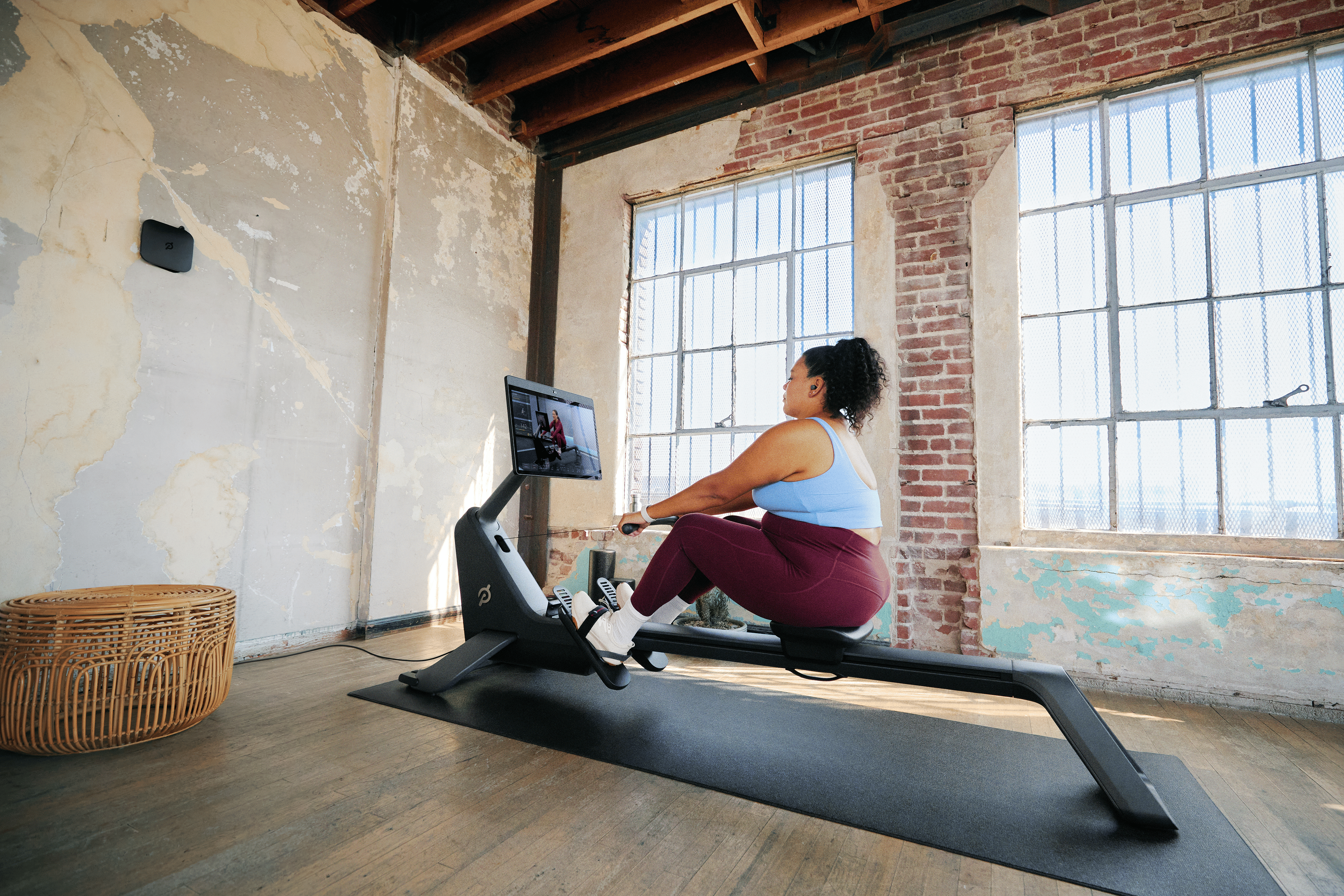 Woman doing a VO2 max workout on the Peloton Row