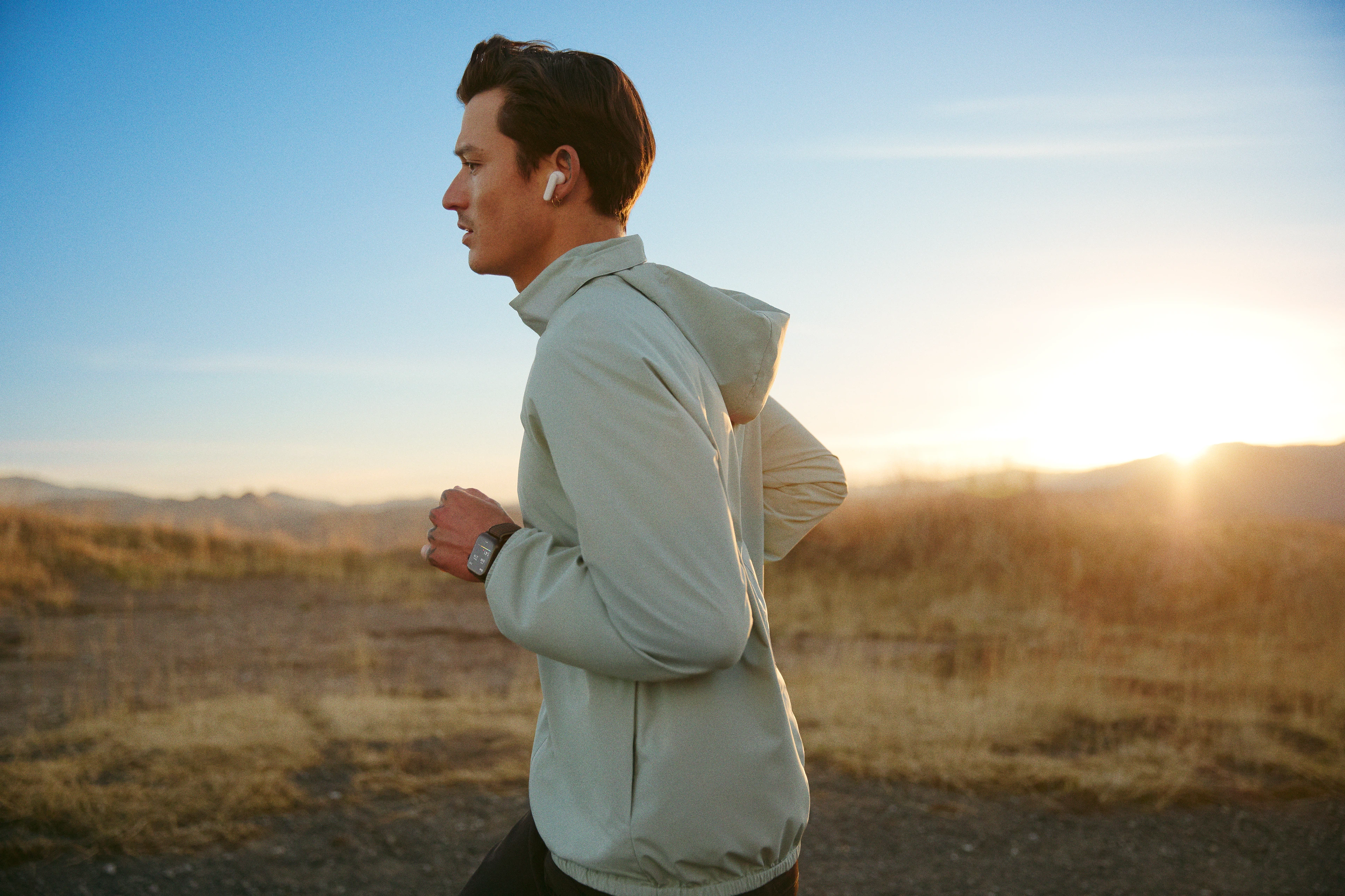 Man running outdoors training for a half marathon with Peloton running classes.
