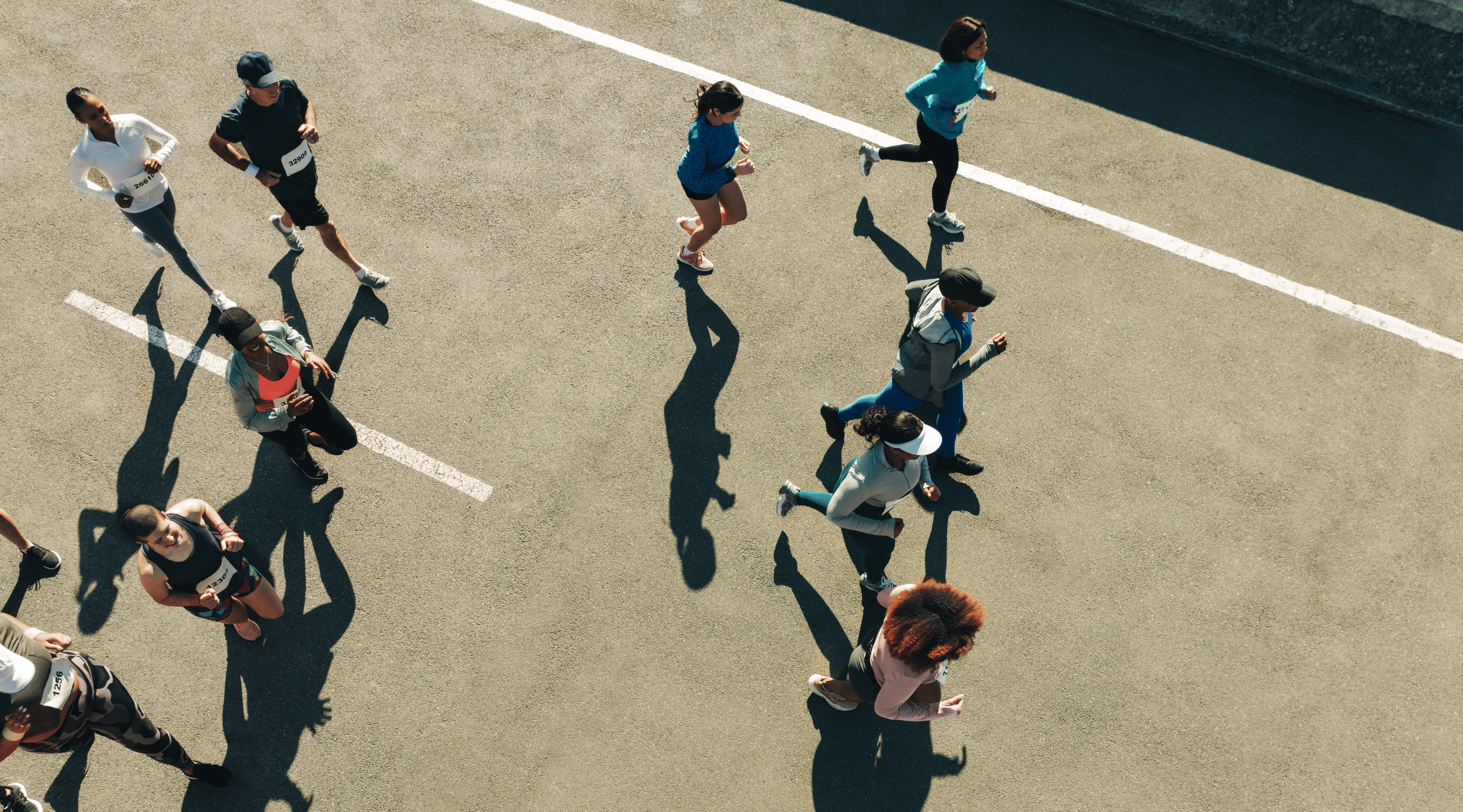 Group of people during a road race, including some people running and some people walking the marathon.