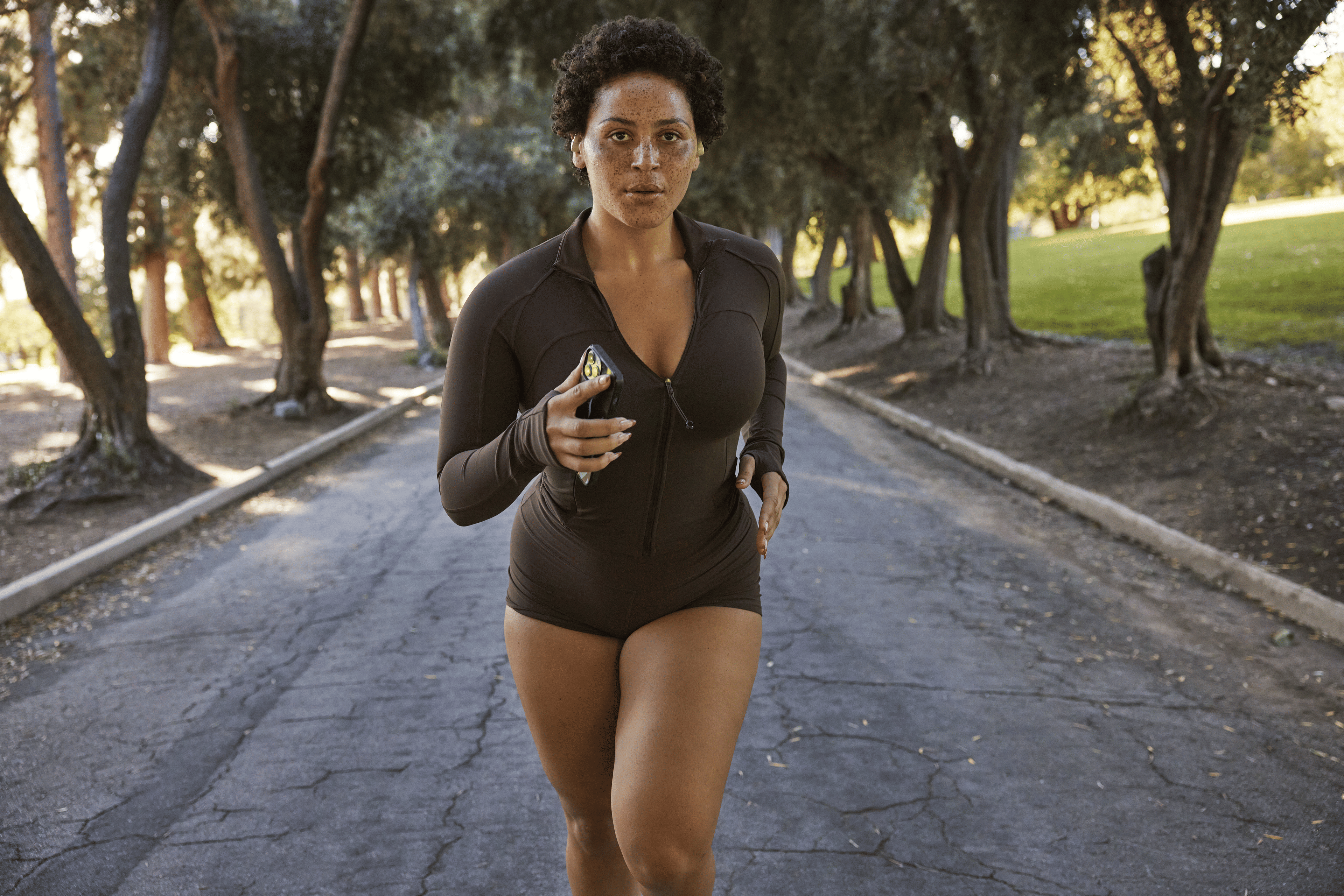 Woman runs outside while holding phone 