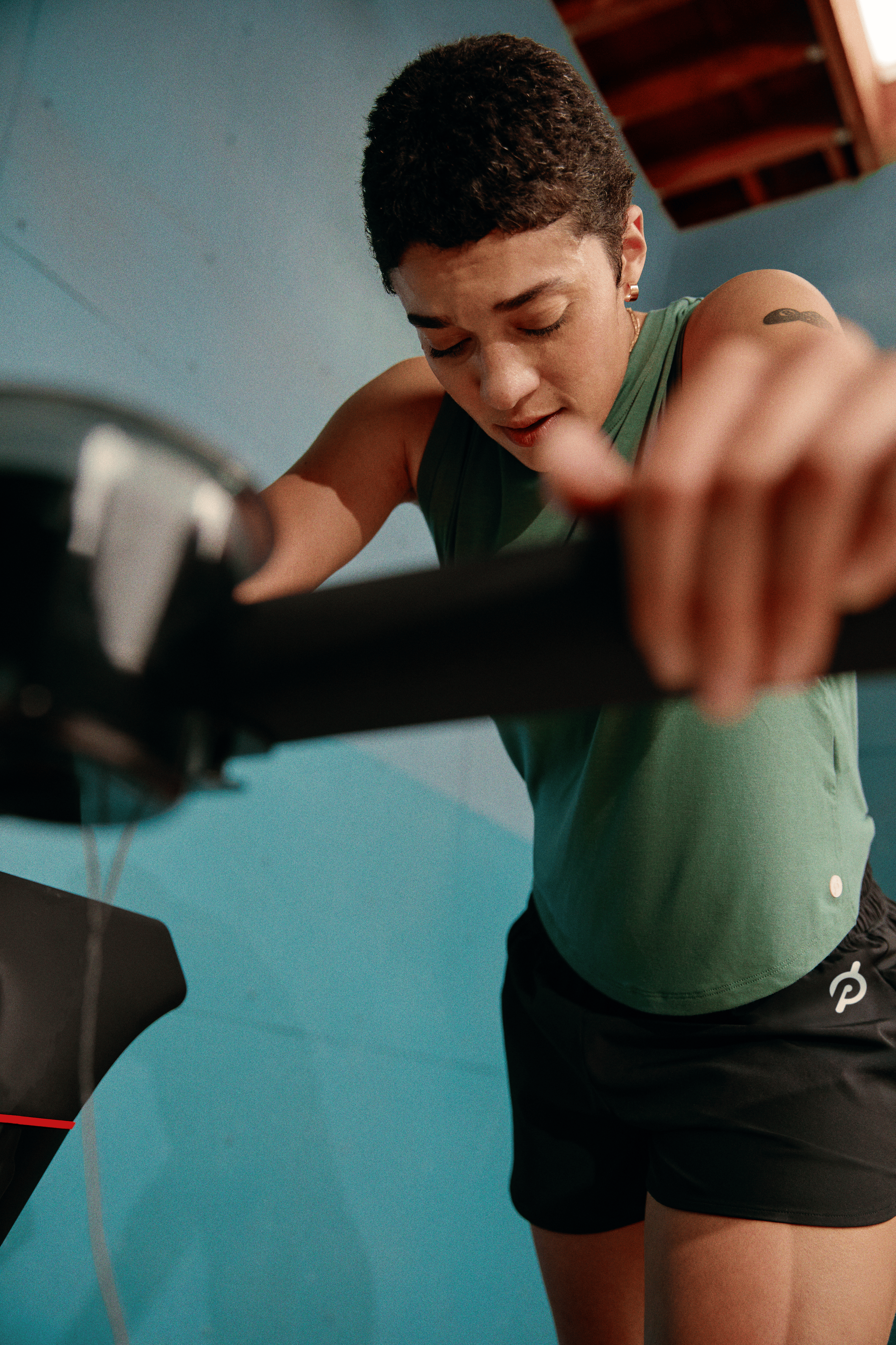 Person resting to catch their breath while doing speed work running on a Peloton treadmill 