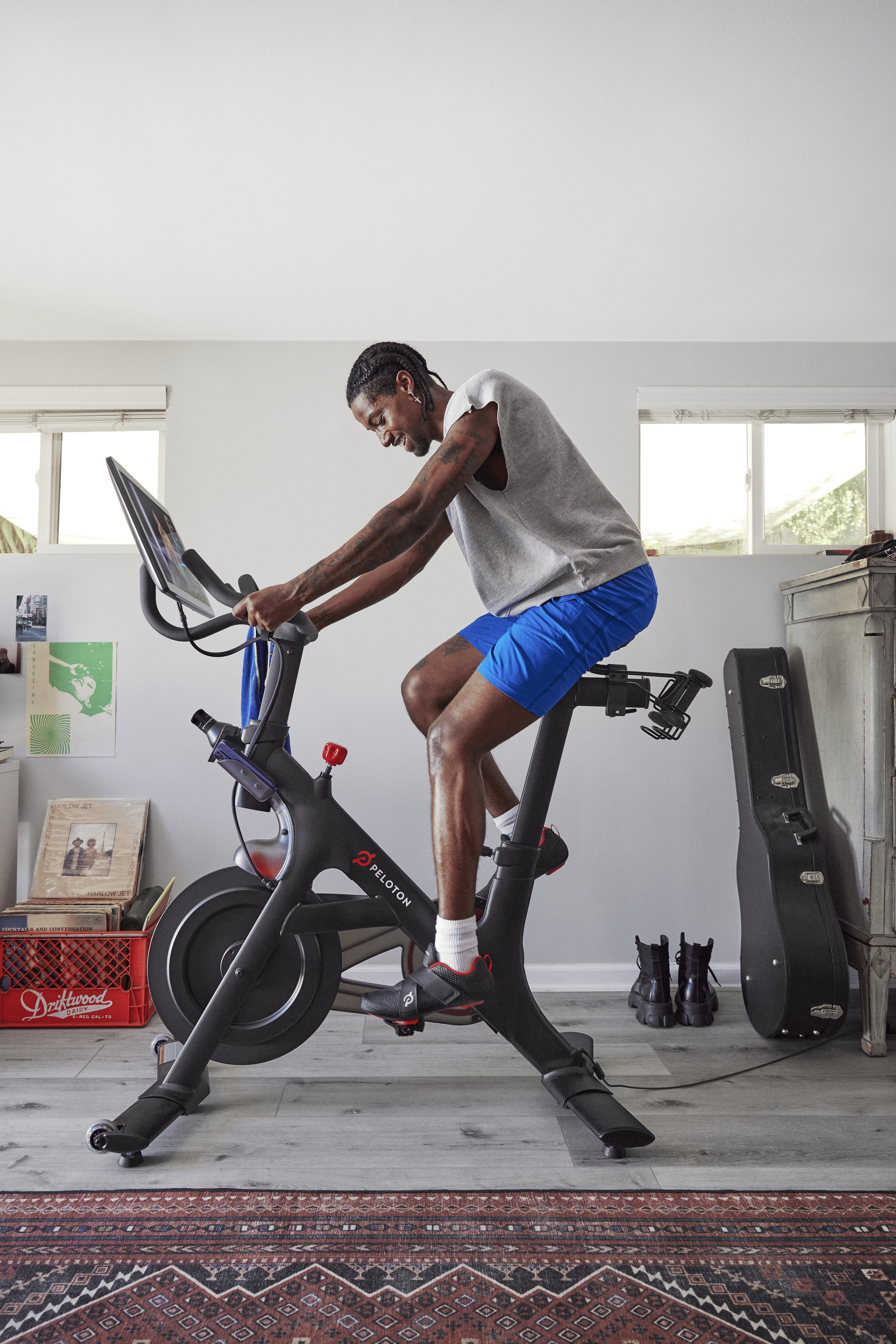 Man rides indoor Peloton Bike at home