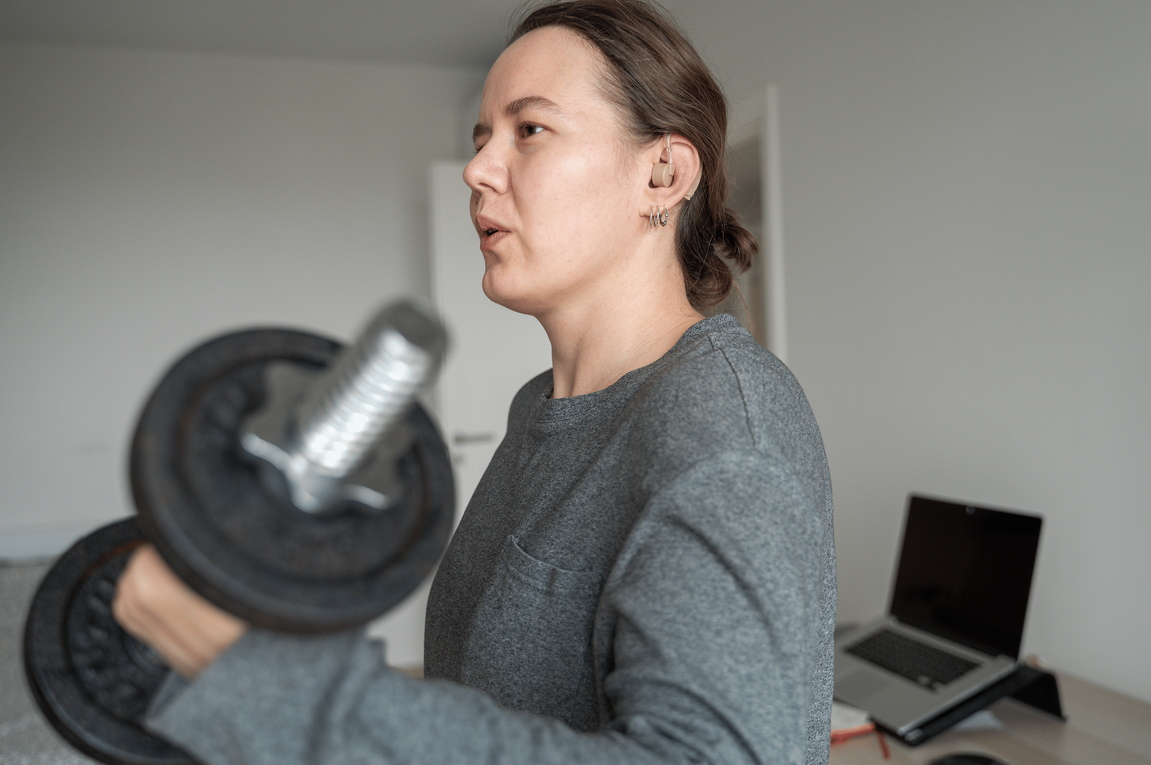 Woman does a bicep curl exercise with dumbbell