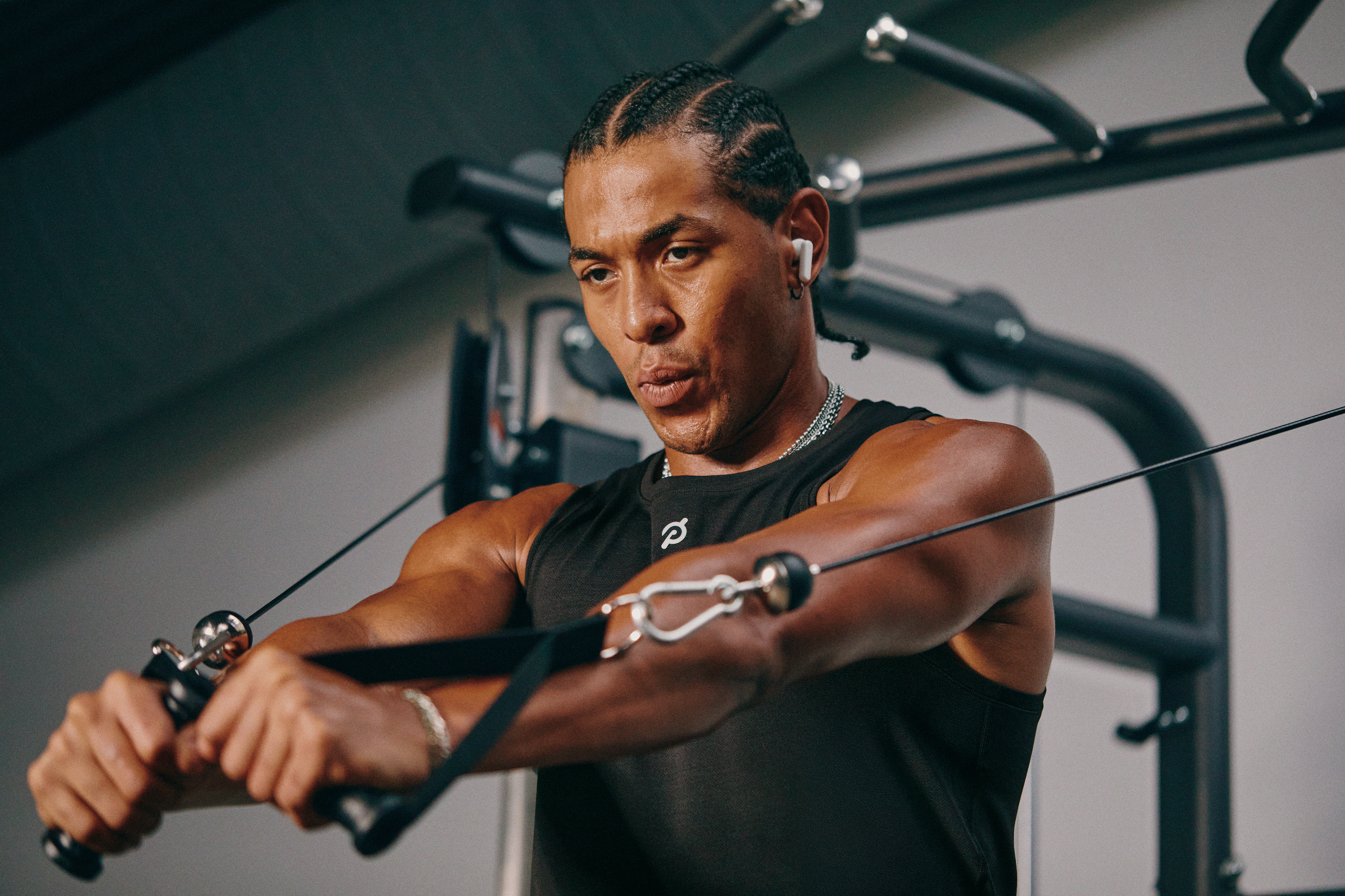 Man doing a cable machine workout as part of his strength training routine.